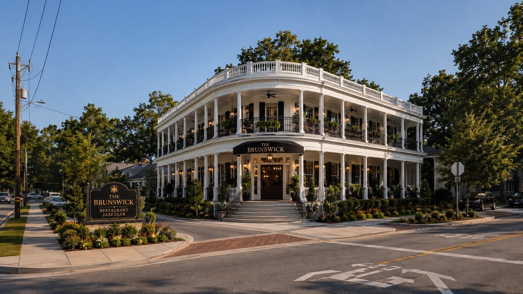 The rebuilt Brunswick at Thrasher and Park, a two-storey white building with wide columned porches on both levels